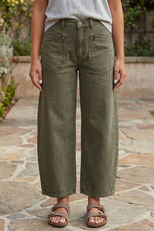 Person wearing olive green wide-leg pants on a stone pathway.